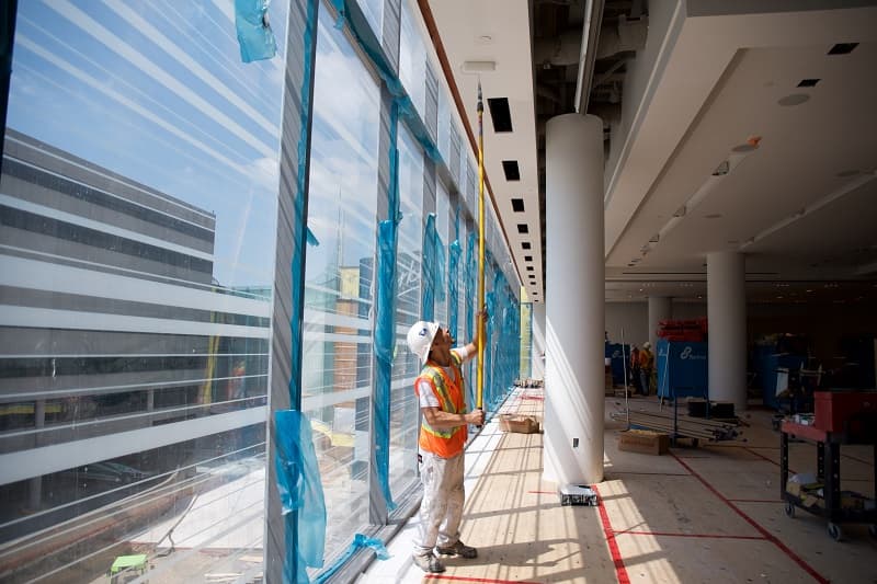 Painter rolling the ceiling of a commercial building under construction