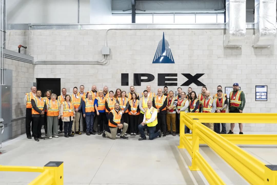 IPEX staff posed infront of newly built and painted distribution centre