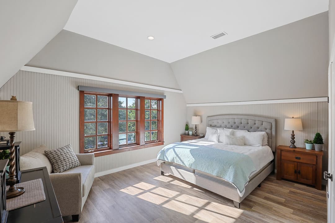 A freshly painted bedroom with sunlight shining in through the window